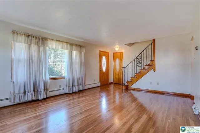 a view of an entryway with wooden floor