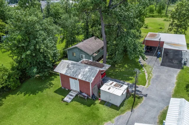 an aerial view of a house with garden space and street view
