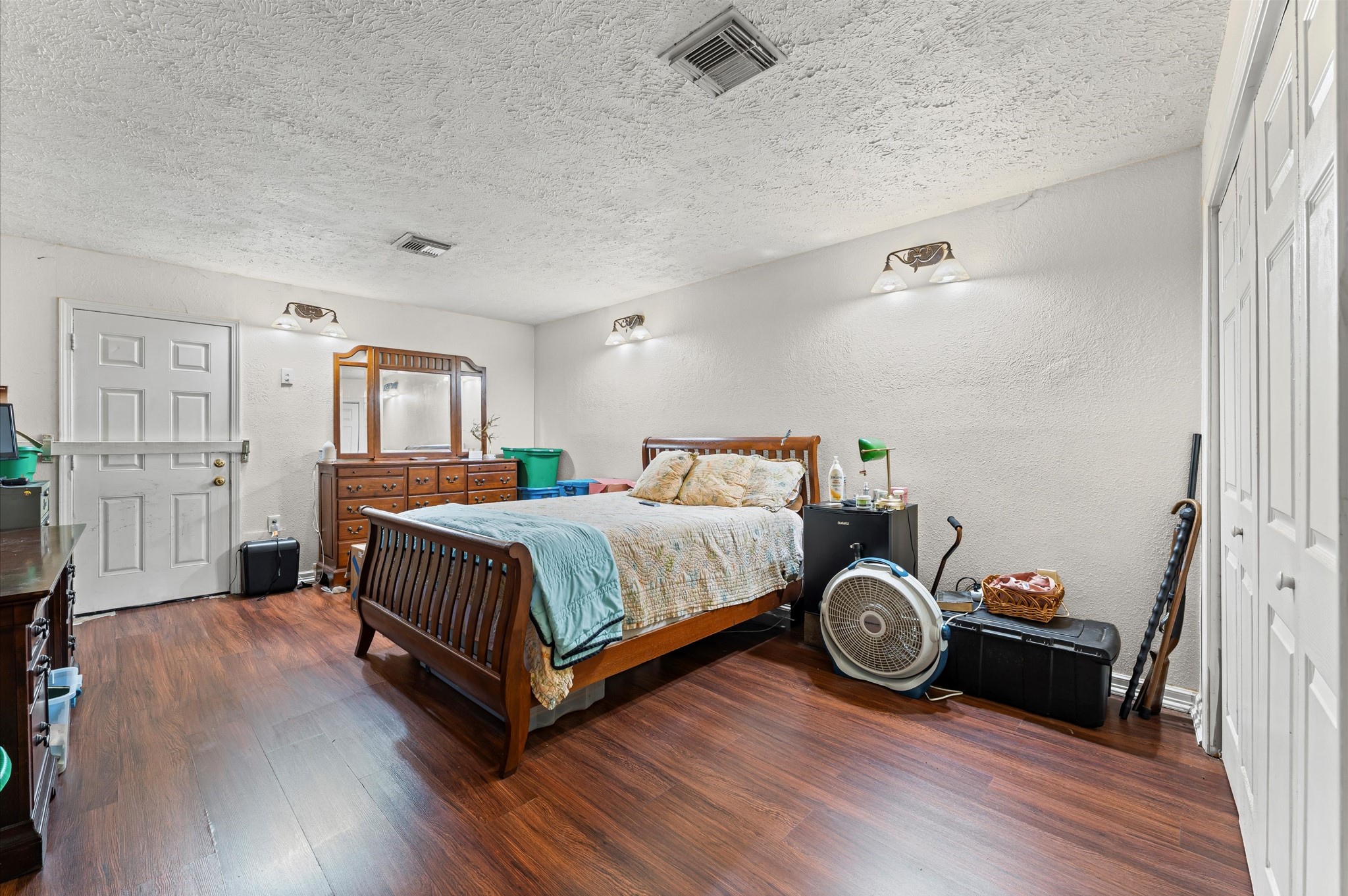 16032 1/2 Ridlon Street Channelview, TX 77530 - Photo 11 of 44 a bedroom with a bed and wooden floor