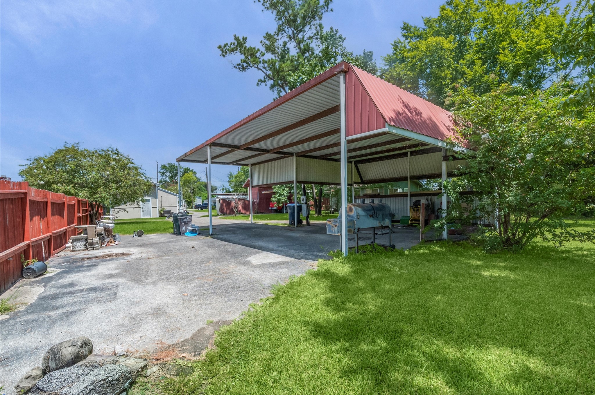 16032 1/2 Ridlon Street Channelview, TX 77530 - Photo 17 of 44 a view of a patio with a table and chairs under an umbrella