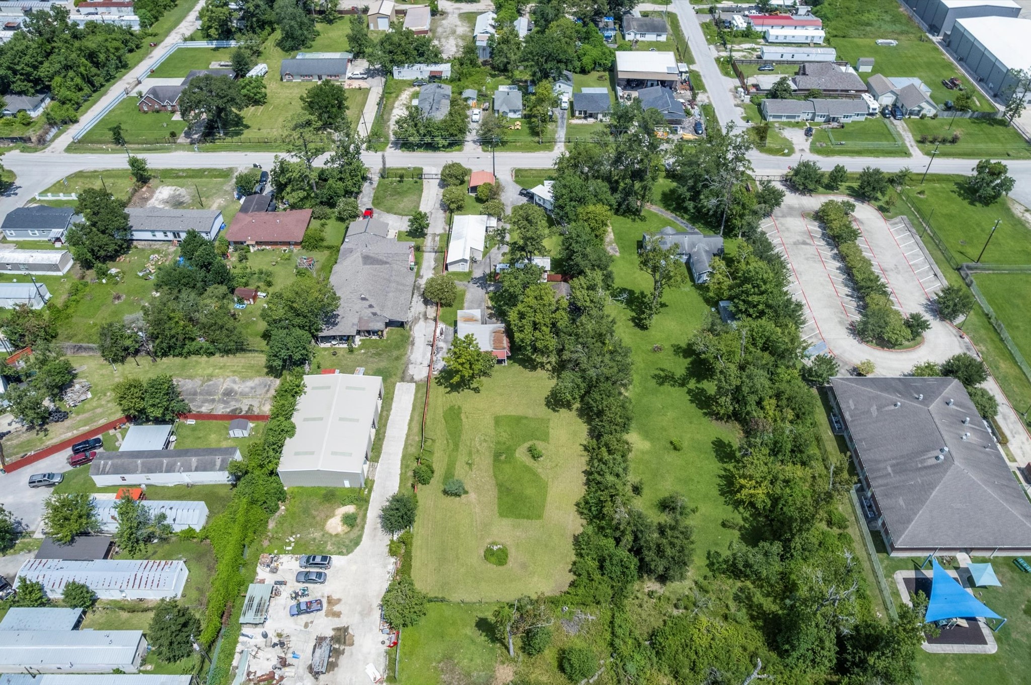 16032 1/2 Ridlon Street Channelview, TX 77530 - Photo 32 of 44 an aerial view of residential houses with outdoor space and trees