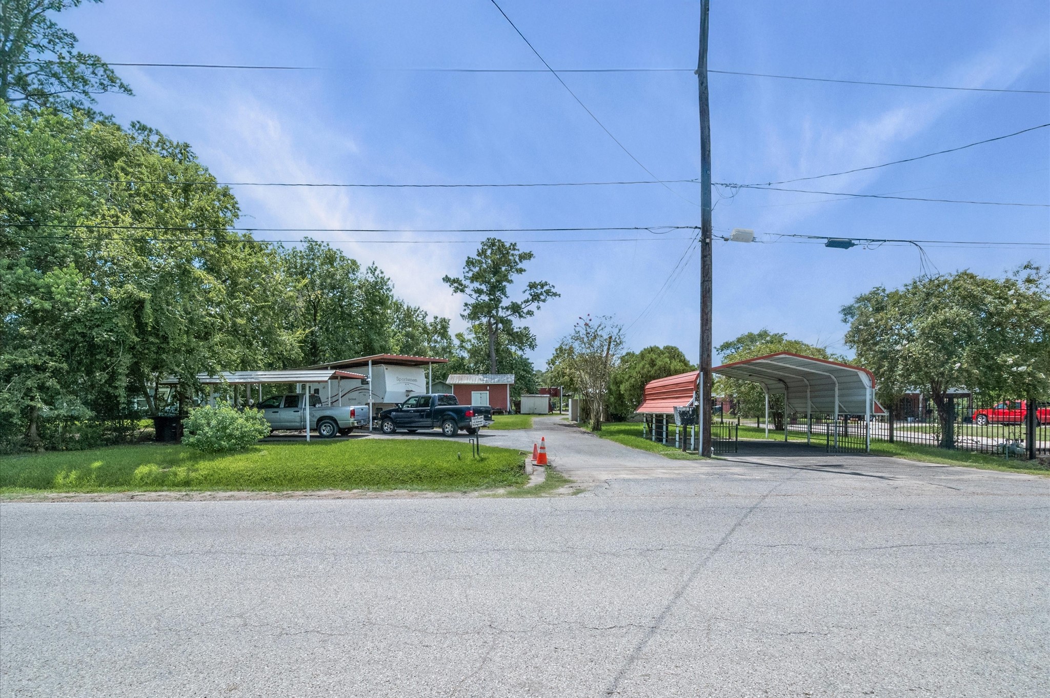 16032 1/2 Ridlon Street Channelview, TX 77530 - Photo 34 of 44 a view of a house with a yard and table and chairs under an umbrella