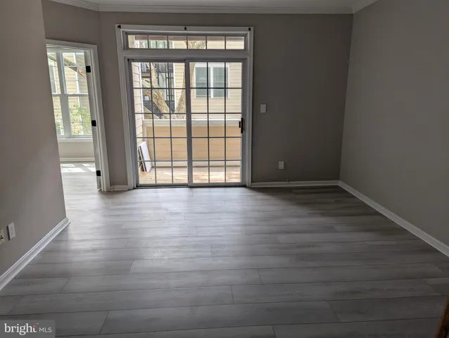 an empty room with wooden floor a fireplace