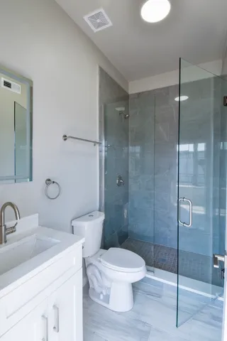 a bathroom with a toilet sink a shower and