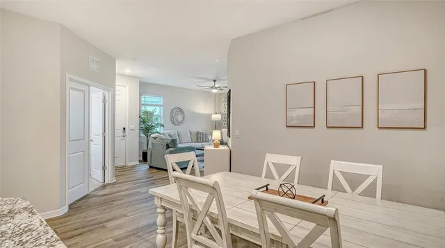 a view of a dining room with furniture and wooden floor