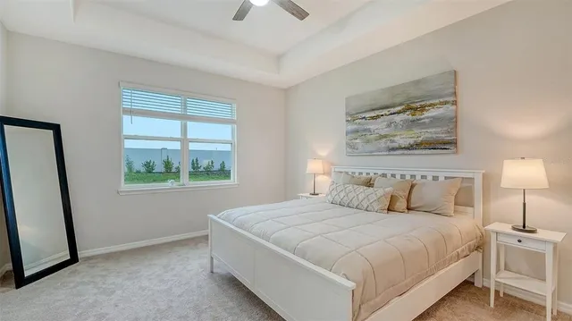 a bedroom with a bed and a painting on the wall