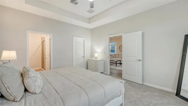 a bedroom with a bed and a mirror