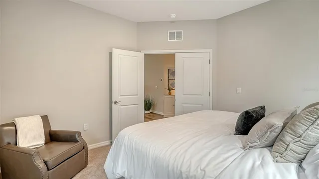 a bedroom with a bed and a couch