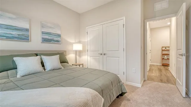 a bedroom with a bed and a mirror