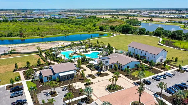 an aerial view of a building with garden space and ocean view