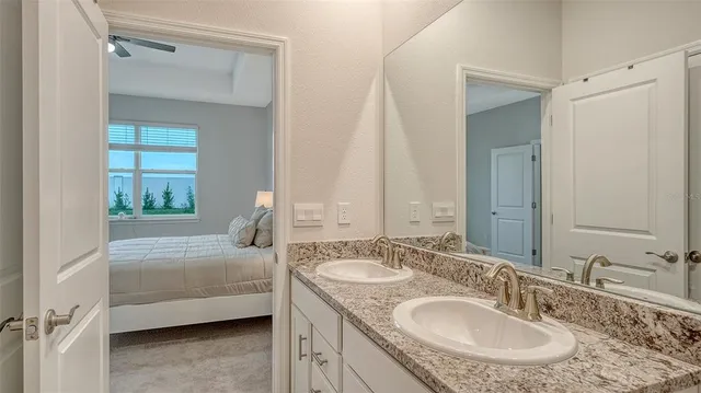 a en suite bathroom with a sink and a mirror