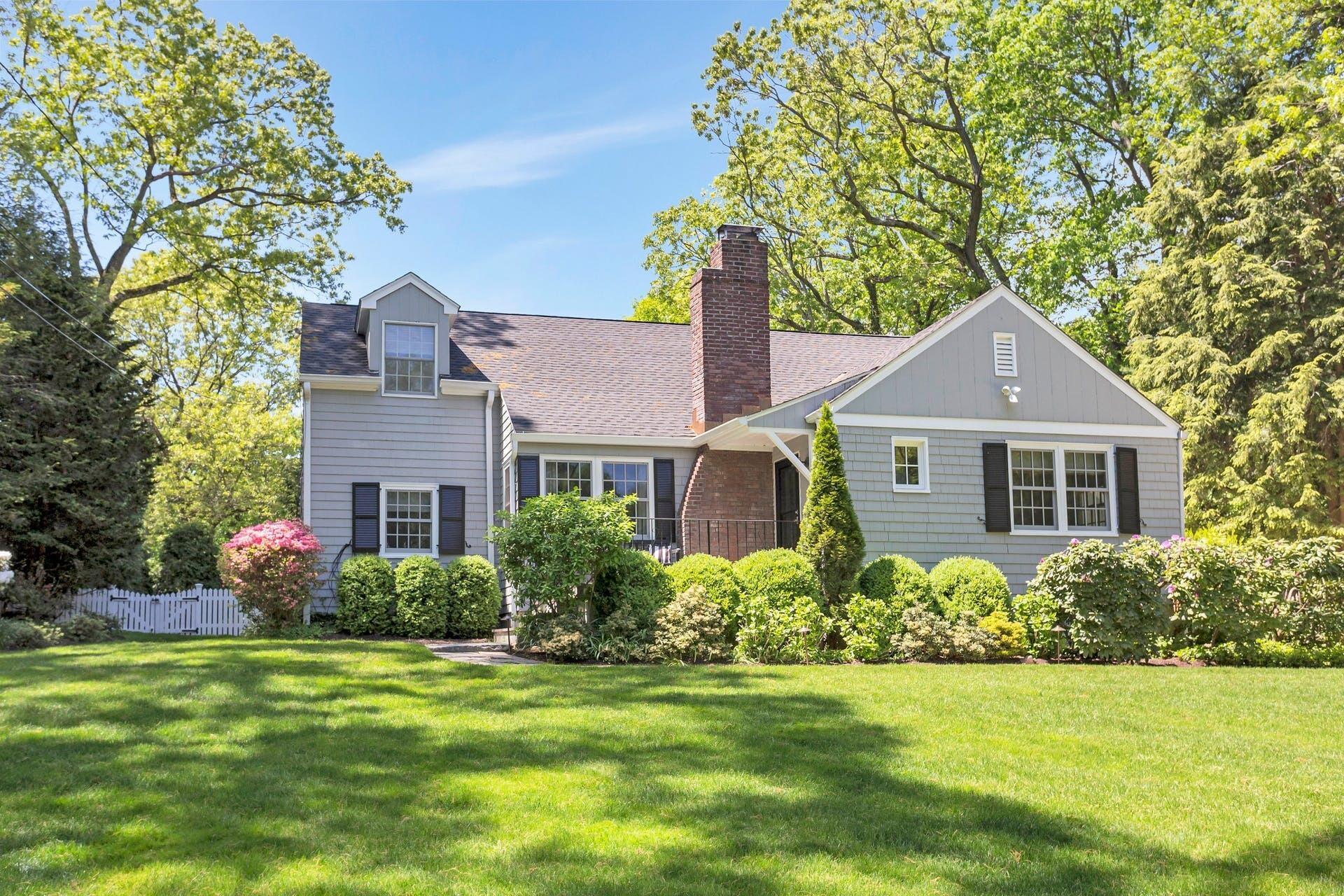 a front view of a house with a garden