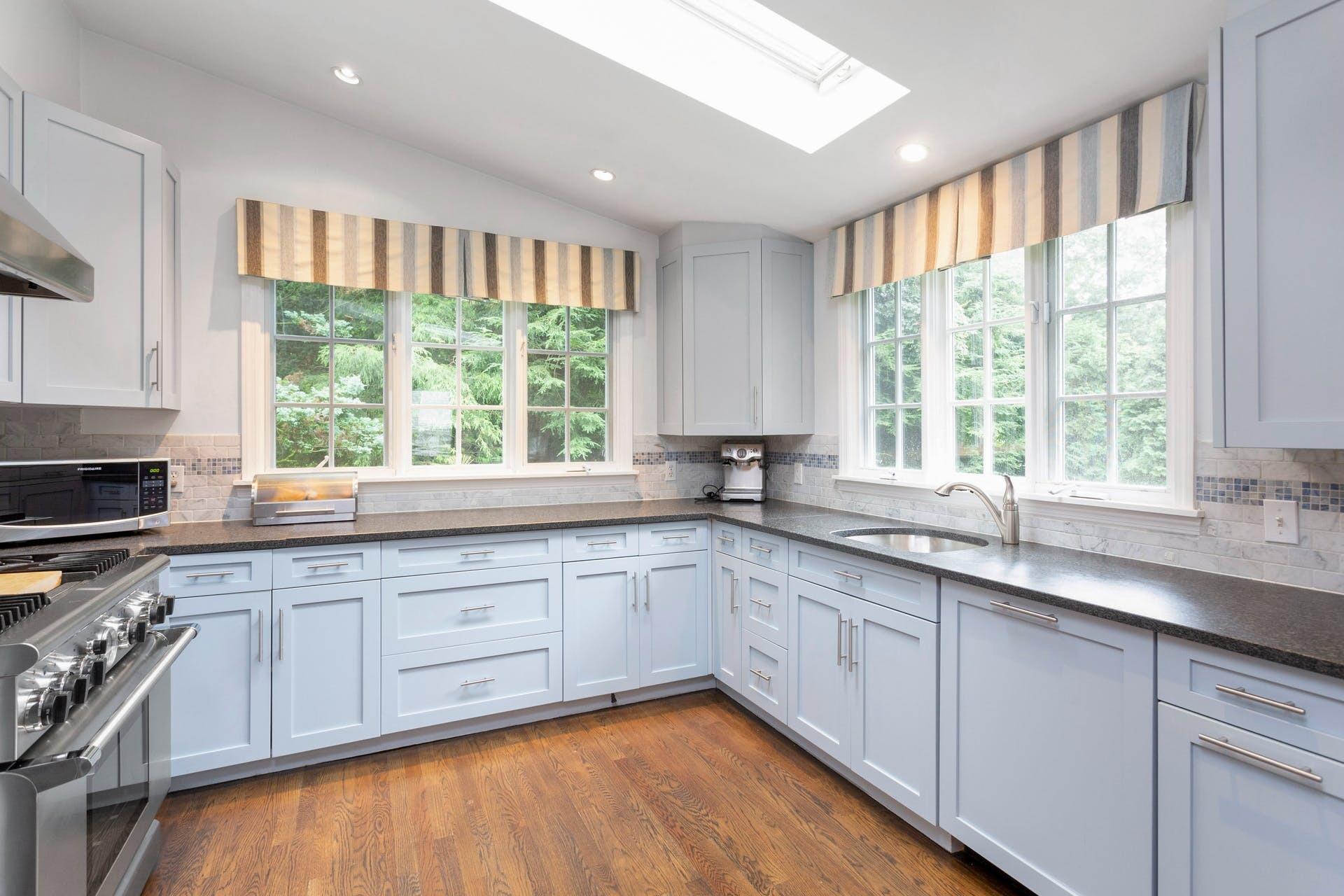 31 Range Road Rowayton, CT 06853 - Photo 10 of 24 a kitchen with stainless steel appliances white cabinets a sink and a window
