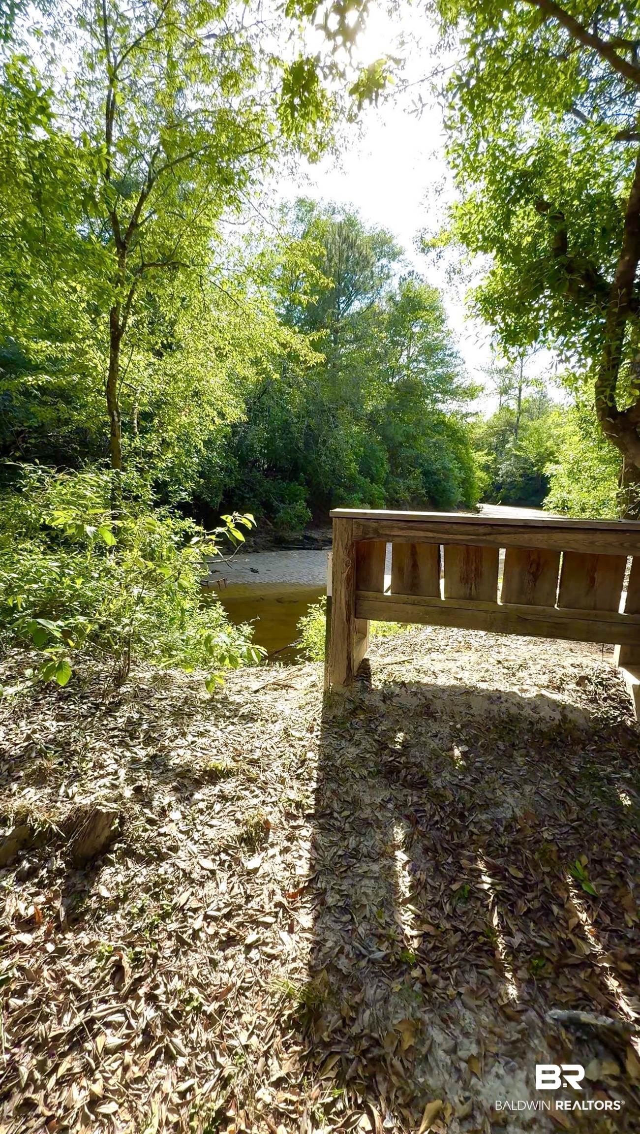 1 Mason Ferry Road Citronelle, AL 36522 - Photo 32 of 40 Wood bench overlooking a natural stream with surrounding mature trees and ground cover