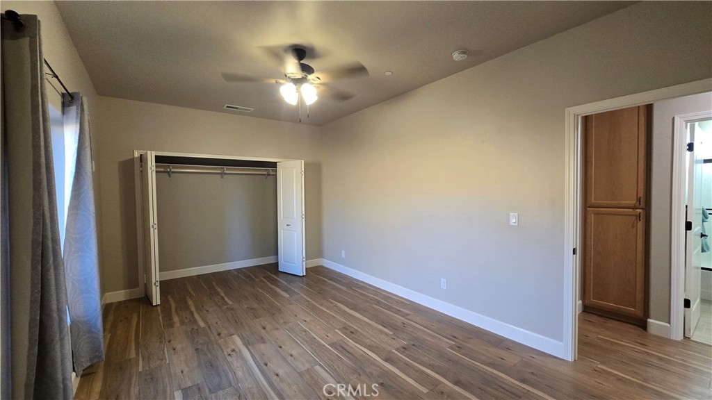 6396 Diamond Paradise, CA 95969 - Photo 28 of 36 an empty room with wooden floor closet and chandelier fan