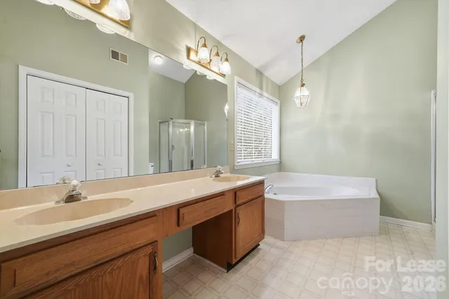 a bathroom with a tub sink and mirror