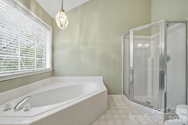 a bathroom with a bathtub and a shower
