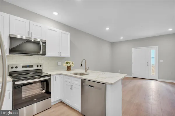 a kitchen with a sink stainless steel appliances and cabinets
