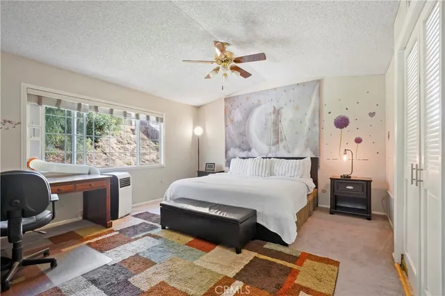 a bed room with a bed and a desk