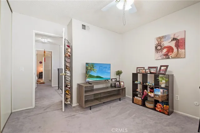 a view of game room with window and ceiling fan