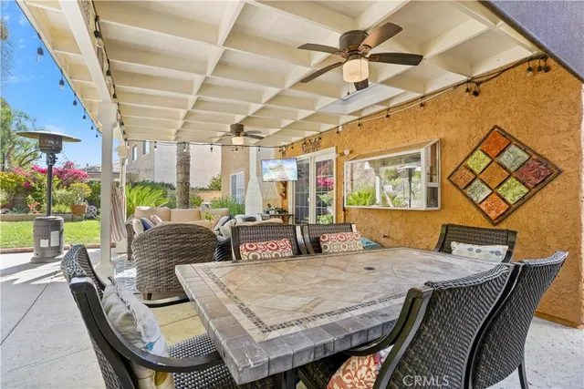a dining room with furniture and a floor to ceiling window