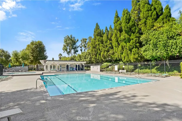 a view of a house with a big yard and potted plants