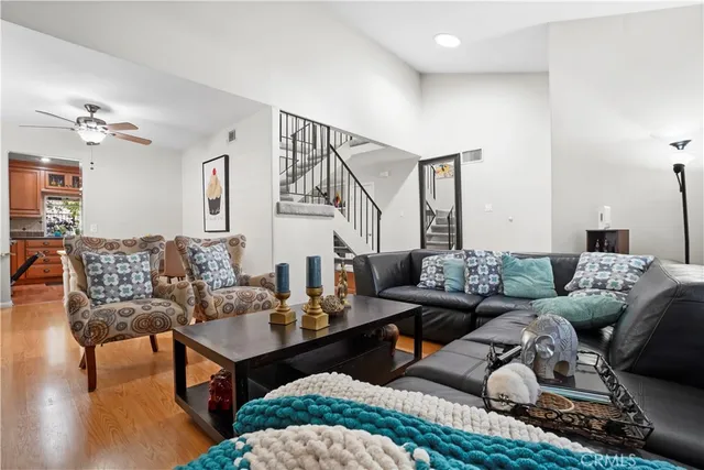 a living room with furniture and wooden floor