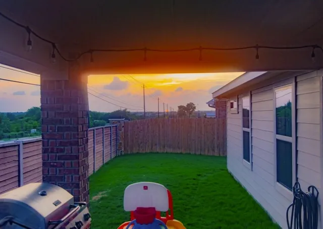 a view of yard with patio