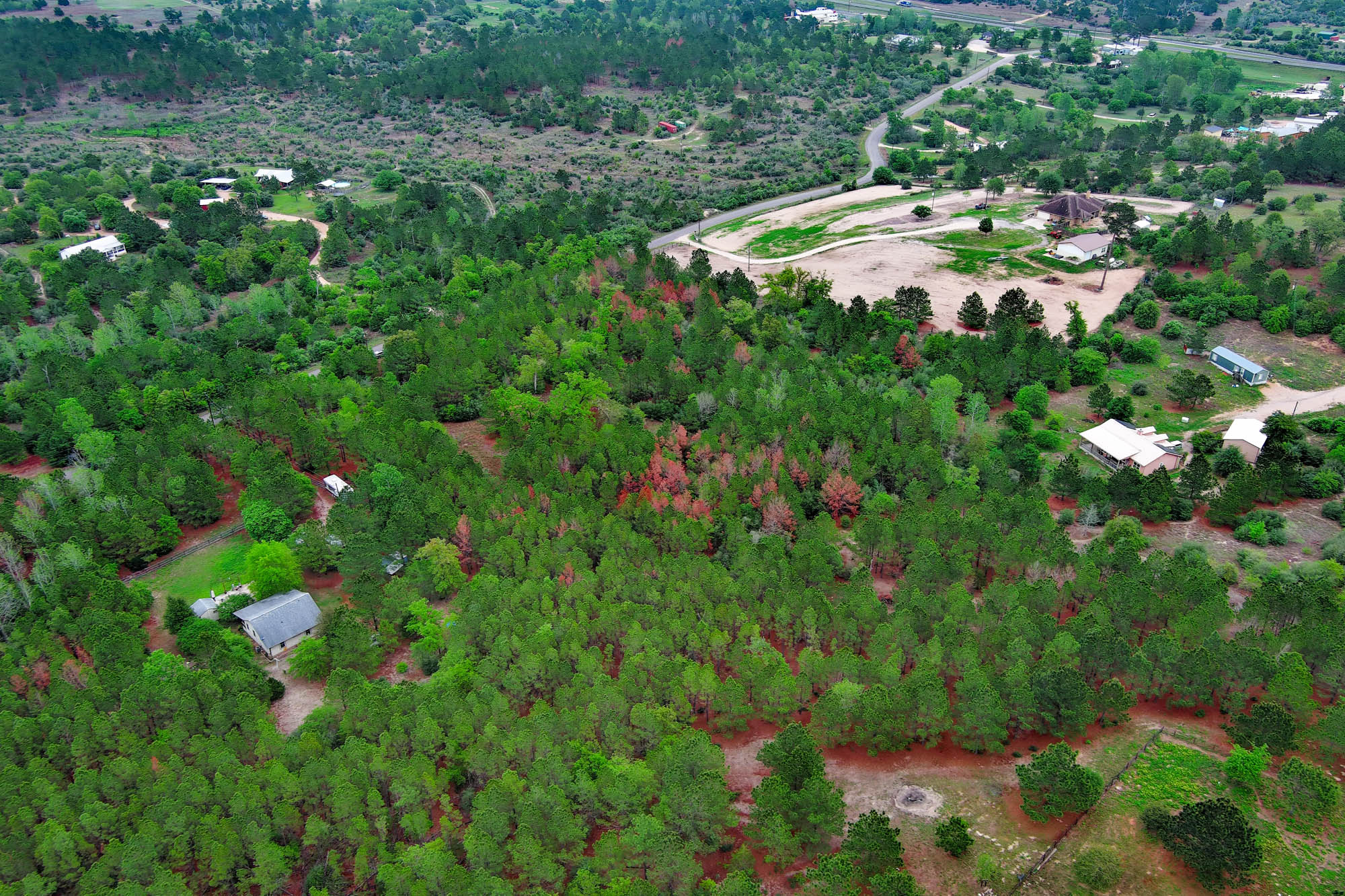 453 Kelley Road East Bastrop, TX 78602 - Photo 9 of 20 an aerial view of residential house with outdoor space and trees all around