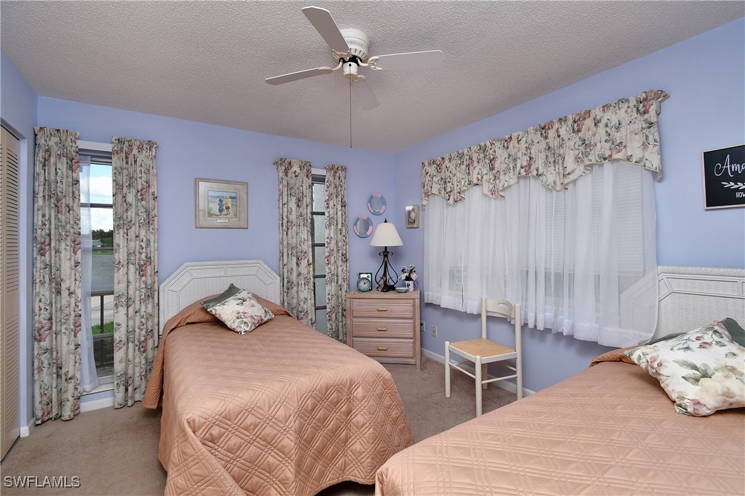 8 Park Ln Circle Lehigh Acres, FL 33936 - Photo 17 of 47 a bedroom with a bed and a chandelier