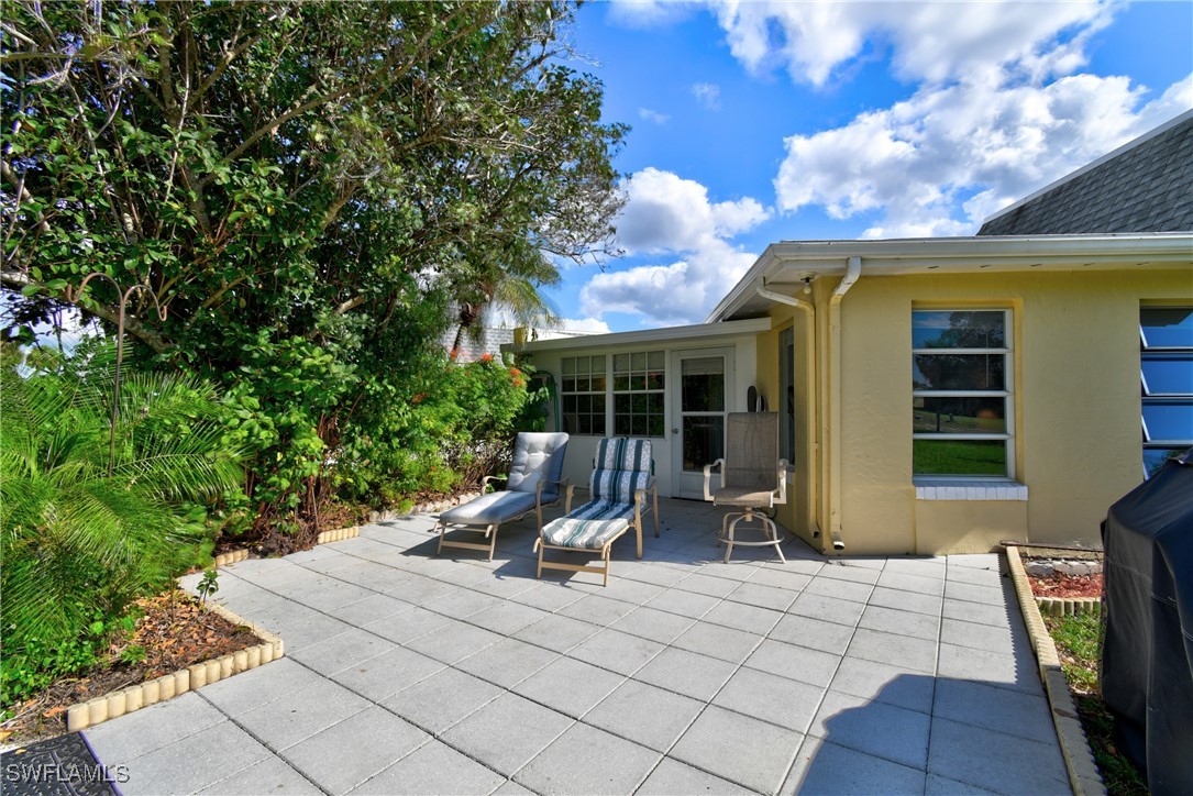 8 Park Ln Circle Lehigh Acres, FL 33936 - Photo 21 of 47 a view of house with backyard outdoor seating and plants