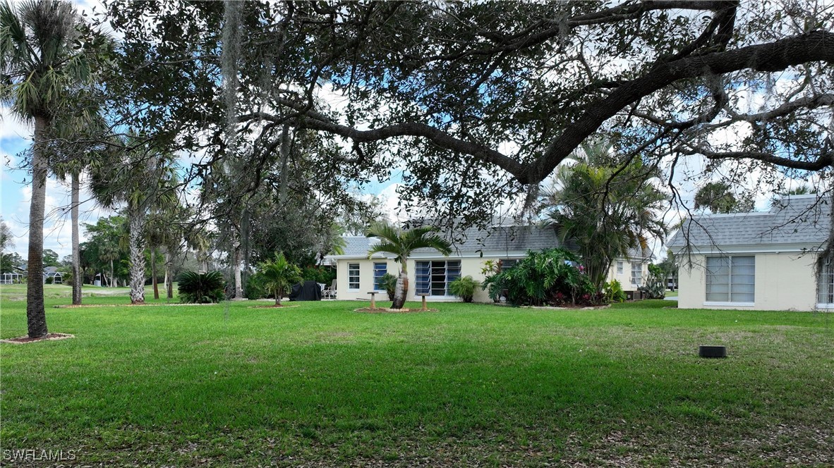 8 Park Ln Circle Lehigh Acres, FL 33936 - Photo 27 of 47 a front view of a house with a yard