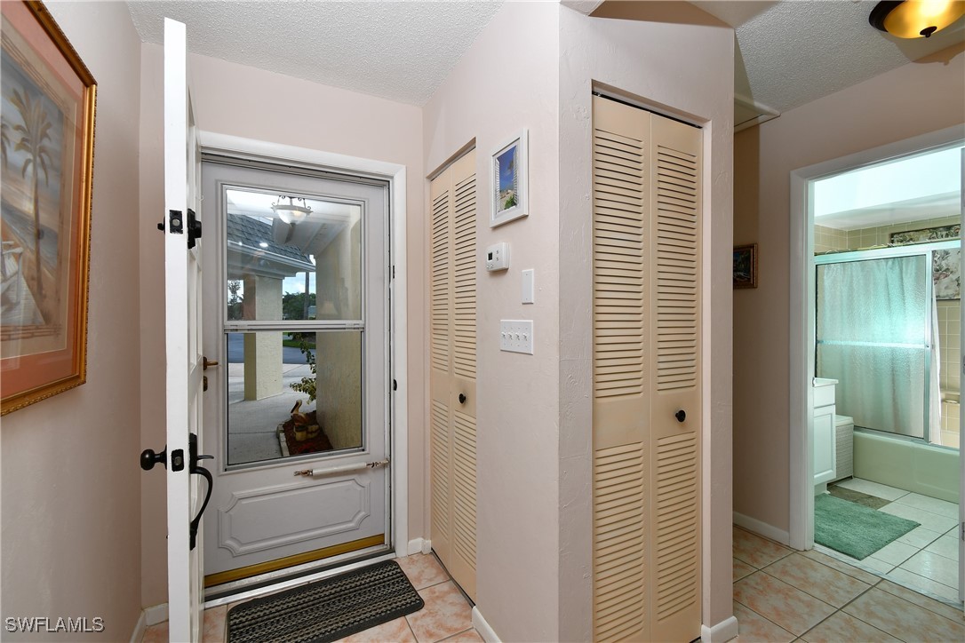 8 Park Ln Circle Lehigh Acres, FL 33936 - Photo 3 of 47 a view of a hallway with bathroom and shower