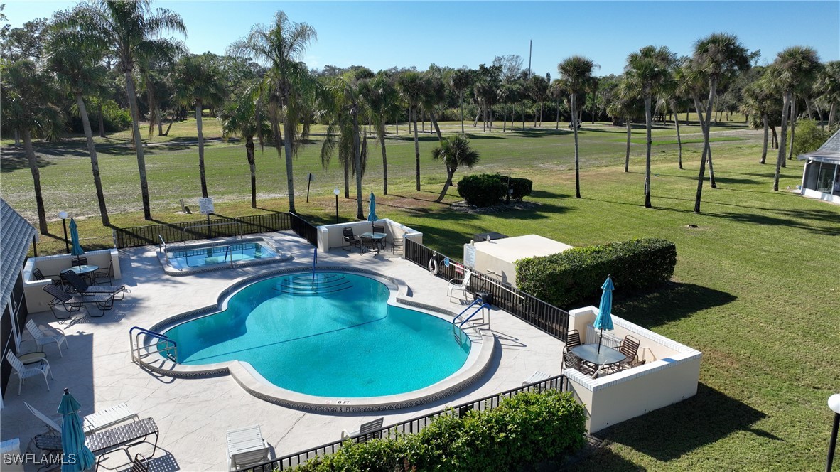 8 Park Ln Circle Lehigh Acres, FL 33936 - Photo 31 of 47 a swimming pool with outdoor seating yard and barbeque oven