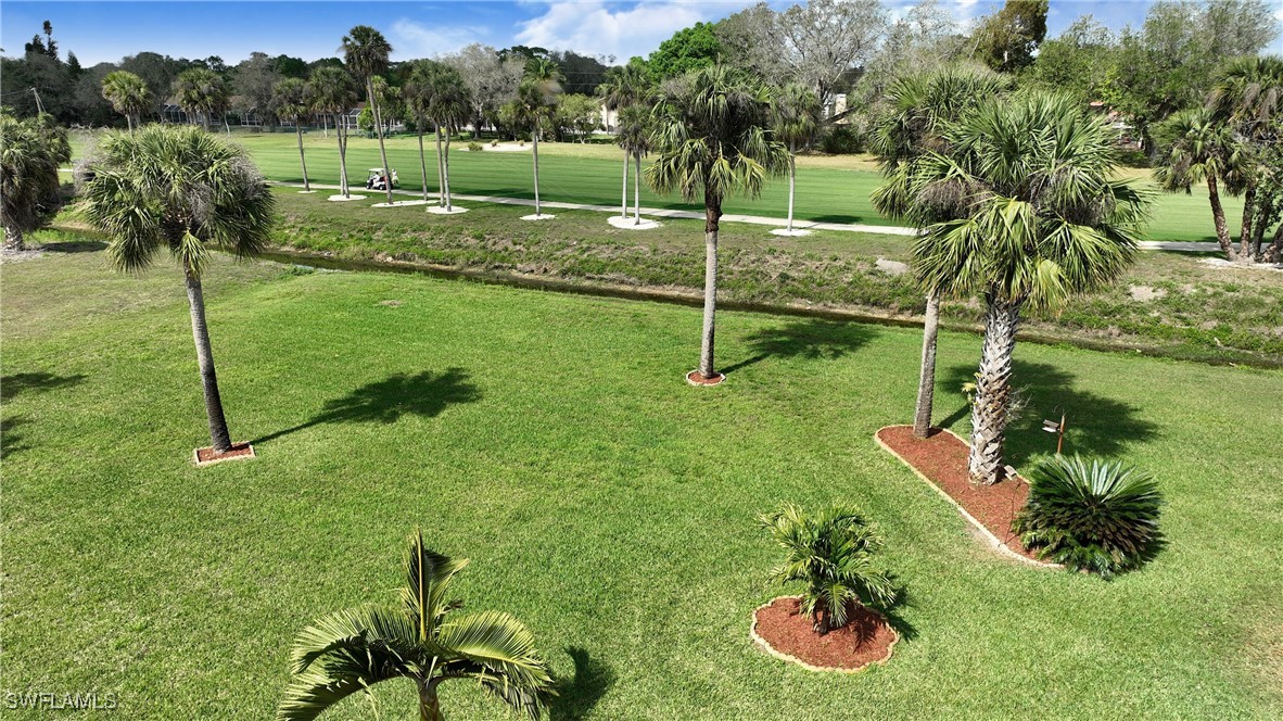 8 Park Ln Circle Lehigh Acres, FL 33936 - Photo 39 of 47 a backyard of a house with lots of green space