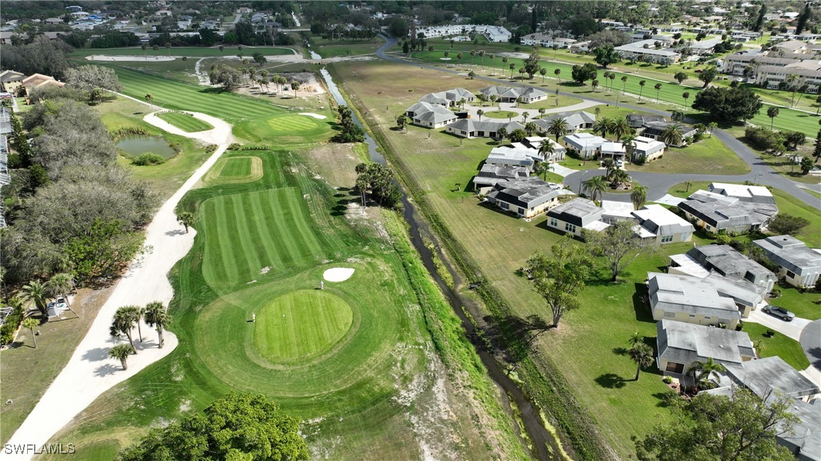8 Park Ln Circle Lehigh Acres, FL 33936 - Photo 42 of 47 an aerial view of a residential houses with outdoor space and lake view