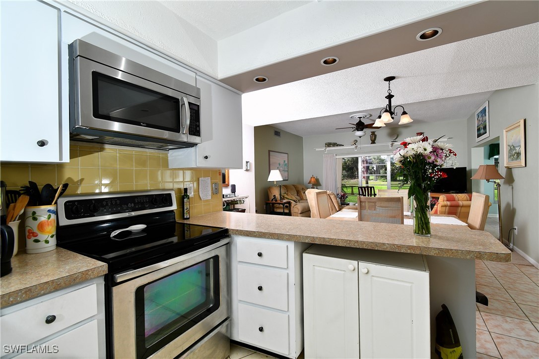 8 Park Ln Circle Lehigh Acres, FL 33936 - Photo 5 of 47 a kitchen with granite countertop a sink and cabinets