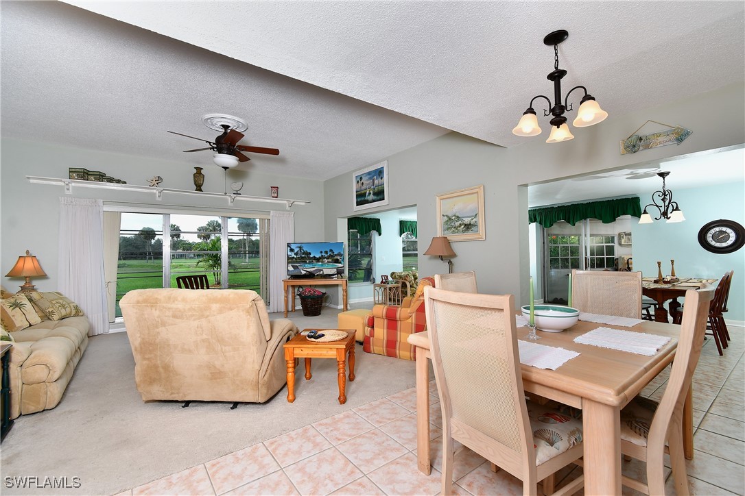 8 Park Ln Circle Lehigh Acres, FL 33936 - Photo 7 of 47 a living room with fireplace furniture and a chandelier