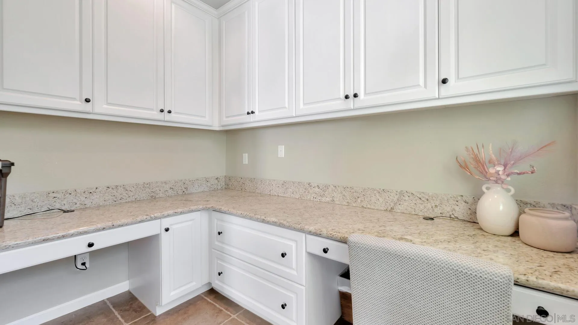 17568 Ralphs Ranch Road San Diego, CA 92127 - Photo 12 of 59 a kitchen with white cabinets and a white counter tops