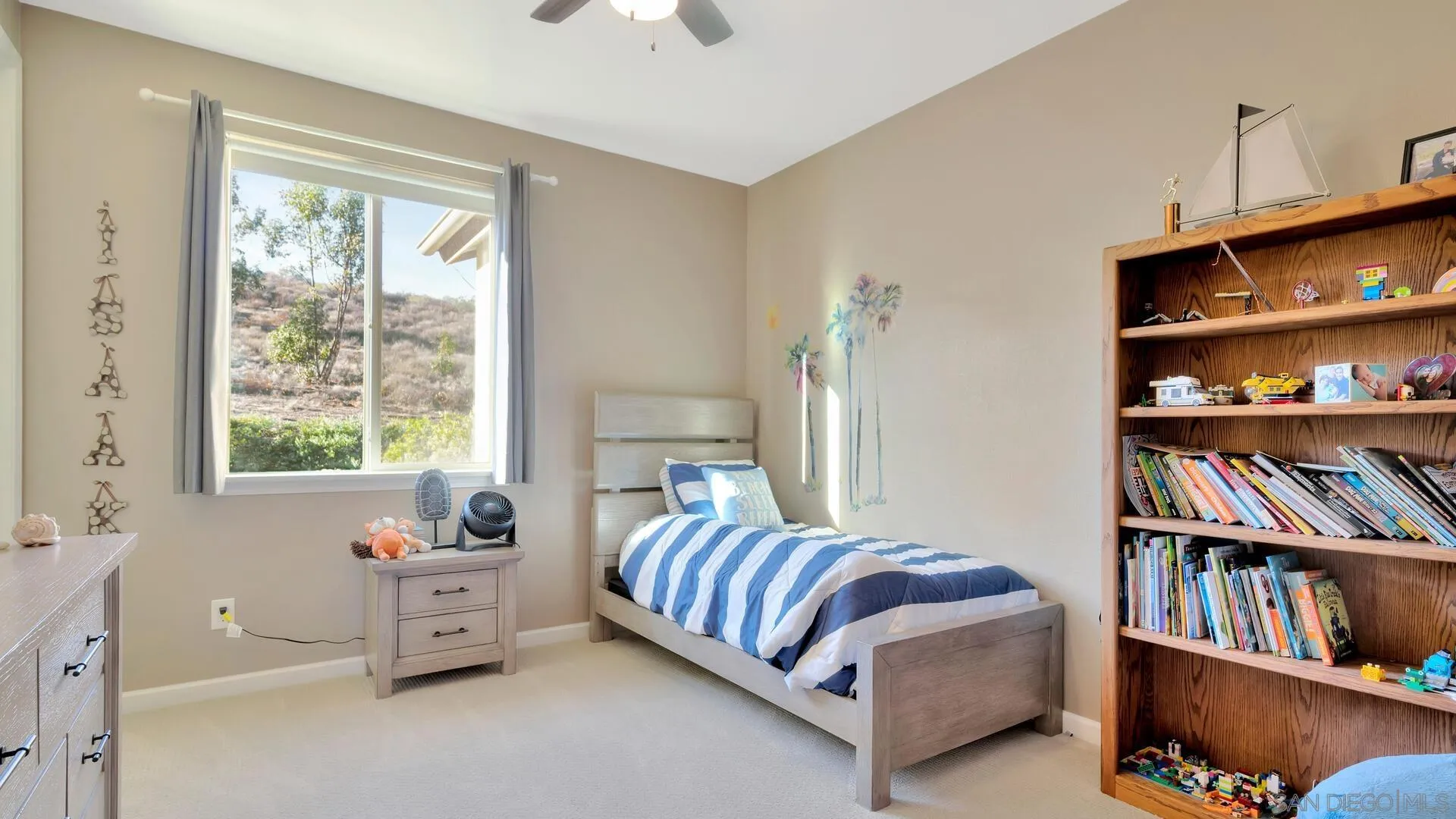 17568 Ralphs Ranch Road San Diego, CA 92127 - Photo 33 of 59 a bedroom with furniture and a book shelf