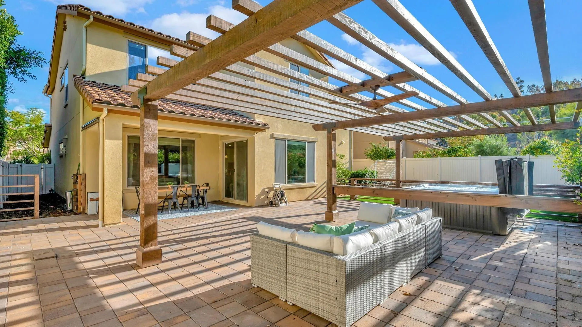 17568 Ralphs Ranch Road San Diego, CA 92127 - Photo 37 of 59 a view of a patio with couches table and chairs with wooden floor and fence