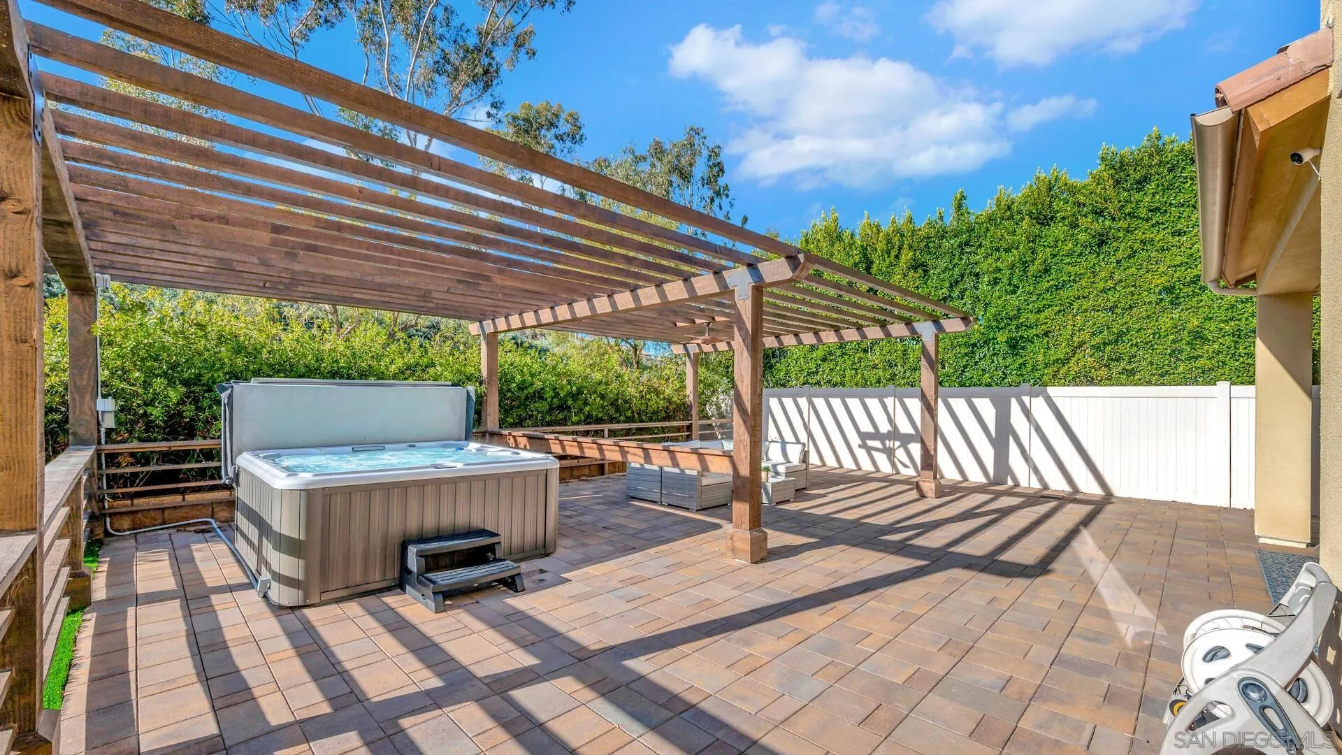 17568 Ralphs Ranch Road San Diego, CA 92127 - Photo 38 of 59 a view of a patio with table and chairs potted plants with wooden floor and fence