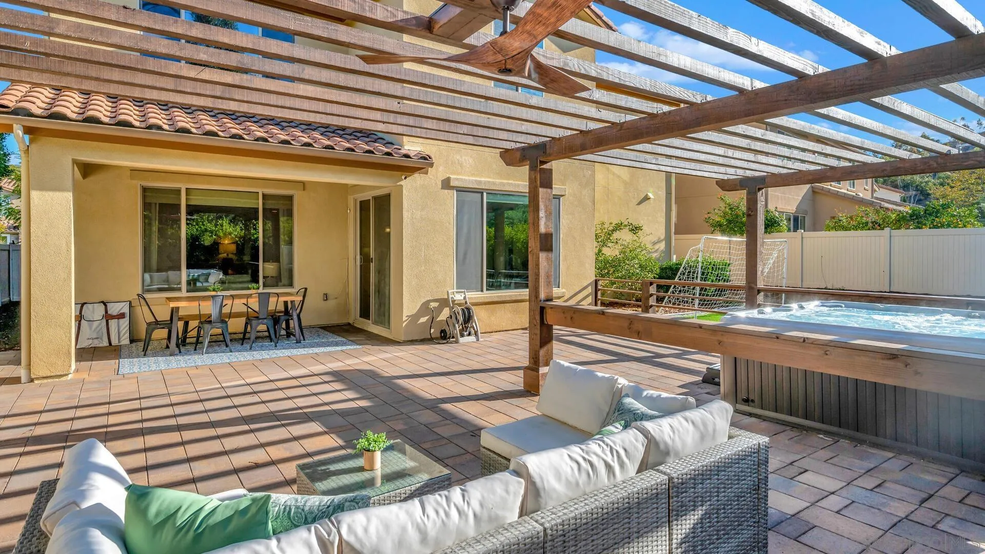 17568 Ralphs Ranch Road San Diego, CA 92127 - Photo 41 of 59 a view of a patio with table and chairs with wooden floor and fence