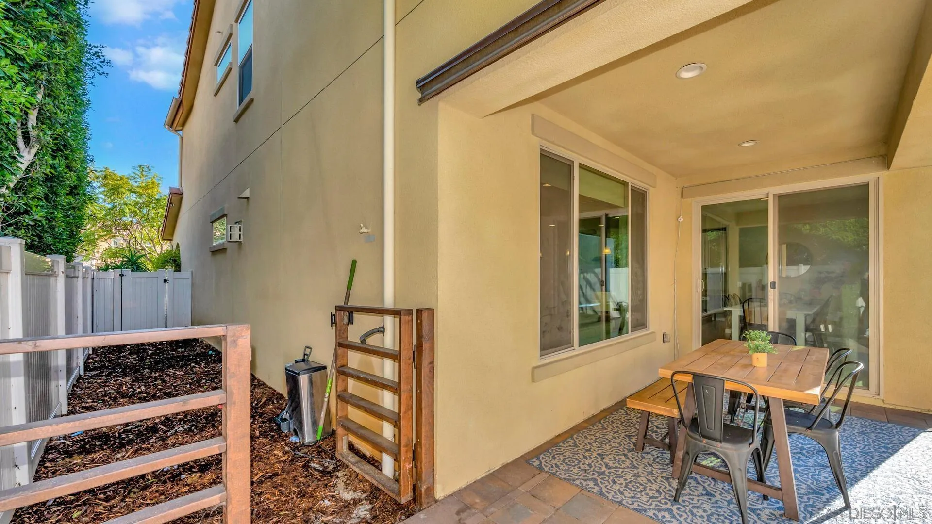 17568 Ralphs Ranch Road San Diego, CA 92127 - Photo 42 of 59 a view of a porch with chairs and wooden fence