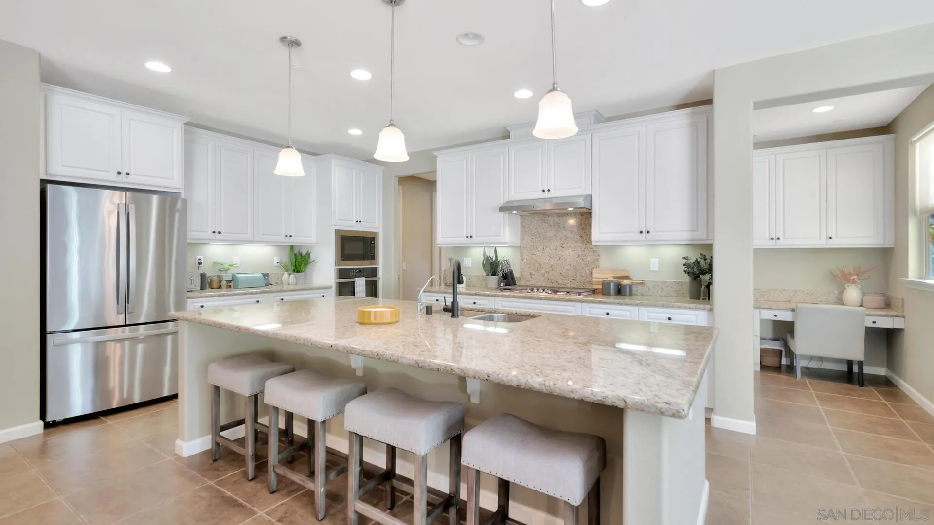 17568 Ralphs Ranch Road San Diego, CA 92127 - Photo 5 of 59 a kitchen with kitchen island granite countertop a stove a sink a refrigerator and a refrigerator with wooden floor