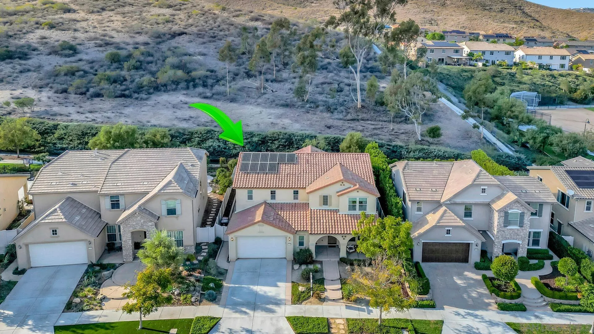 17568 Ralphs Ranch Road San Diego, CA 92127 - Photo 52 of 59 an aerial view of multiple houses with a yard