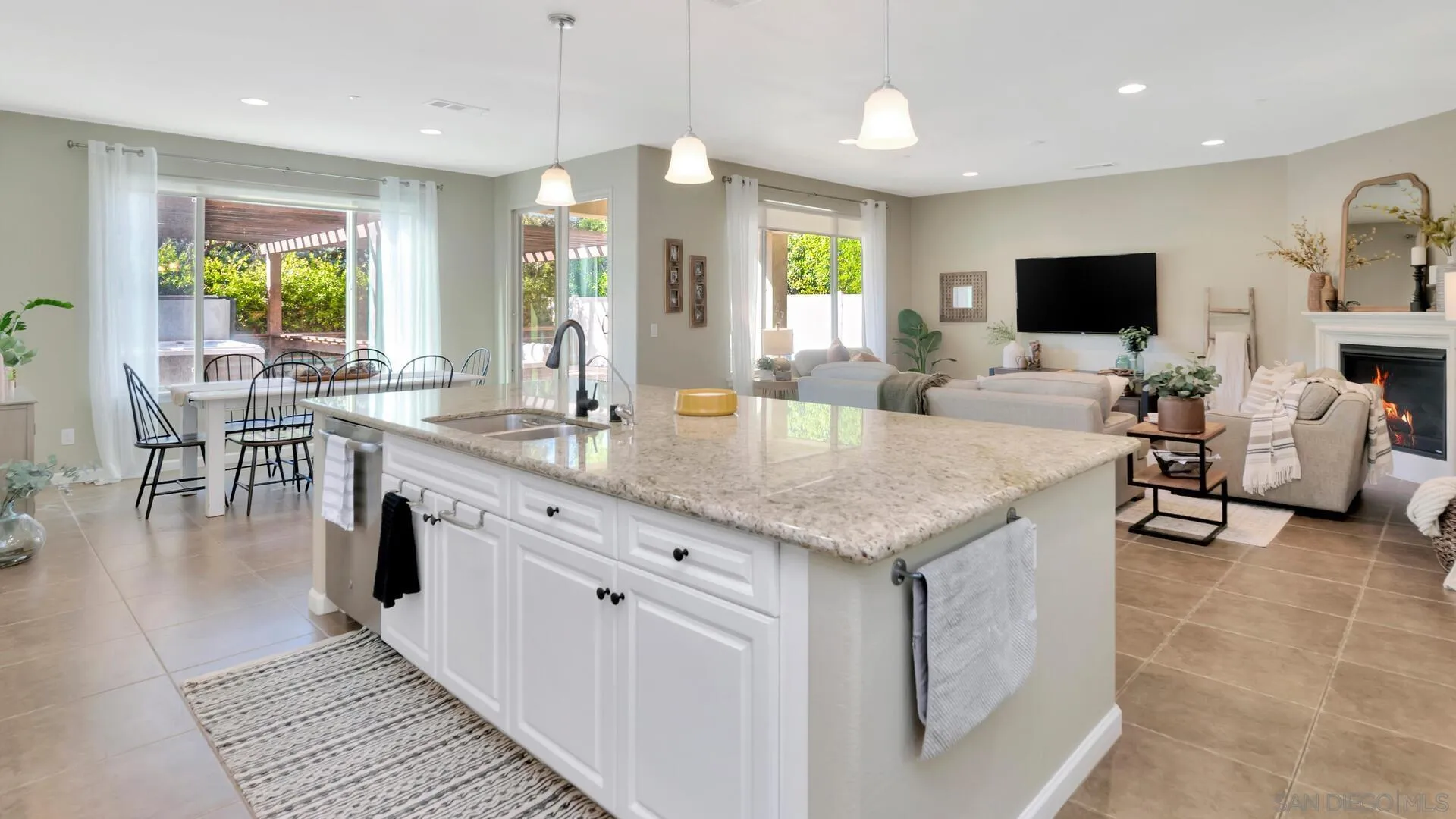 17568 Ralphs Ranch Road San Diego, CA 92127 - Photo 8 of 59 a kitchen with granite countertop lots of counter top space dining table and stainless steel appliances