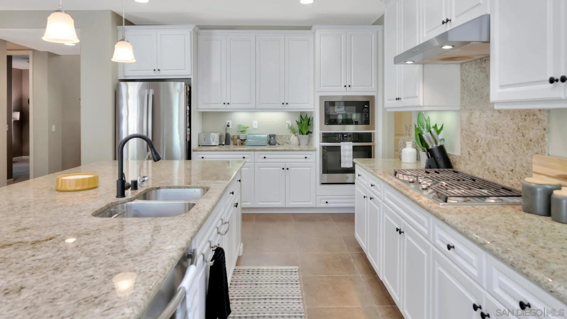 17568 Ralphs Ranch Road San Diego, CA 92127 - Photo 9 of 59 a kitchen with stainless steel appliances granite countertop a sink stove and refrigerator