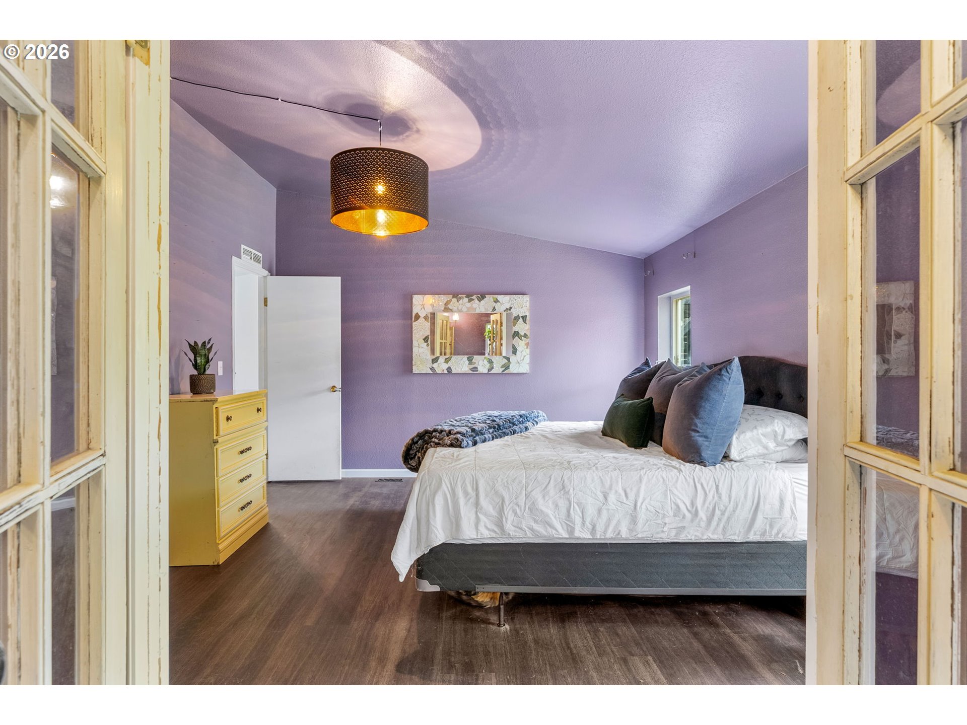 11 2nd Street Carson, WA 98610 - Photo 16 of 40 a bedroom with a bed and a chandelier