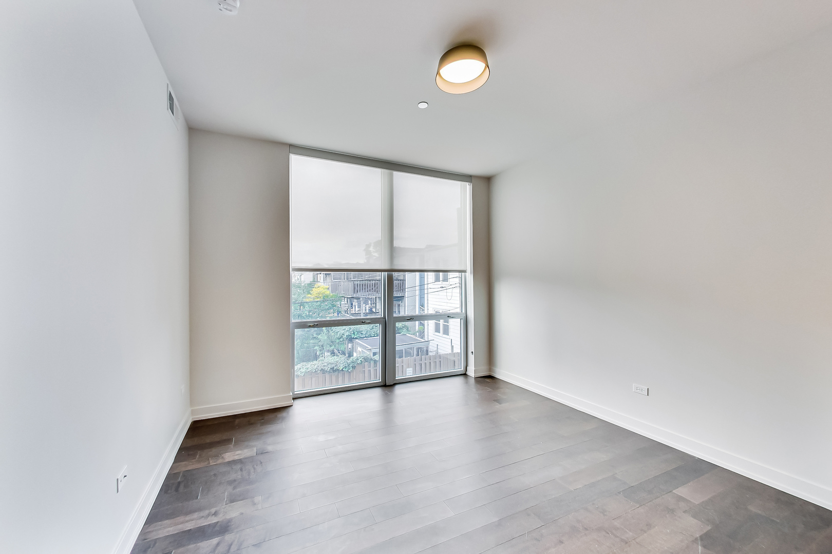 Undisclosed Address Chicago, IL 60613 - Photo 7 of 13 an empty room with wooden floor and windows